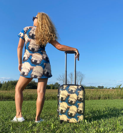 wheaten puppy design carry-on suitcase, with model in wheaten puppy t-shirt dress from the back